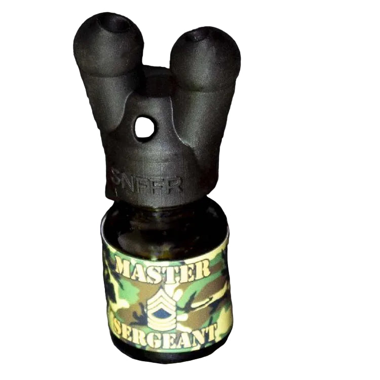 A black double-barrel sight or muzzle device mounted on a small bottle with a green camouflage label reading 'MASTER SERGEANT'.