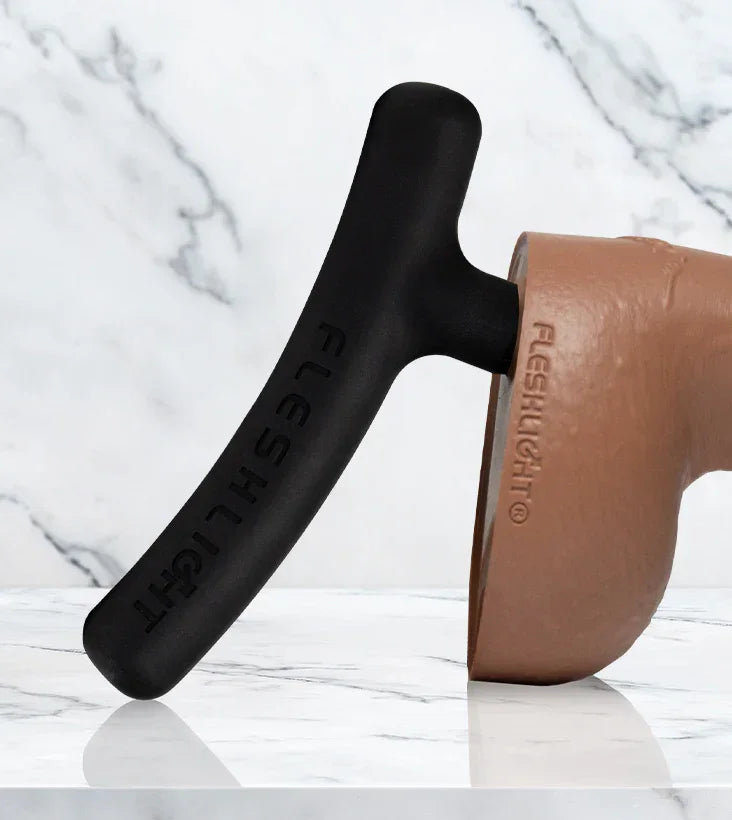 Black and brown Fleshlight on a marble background