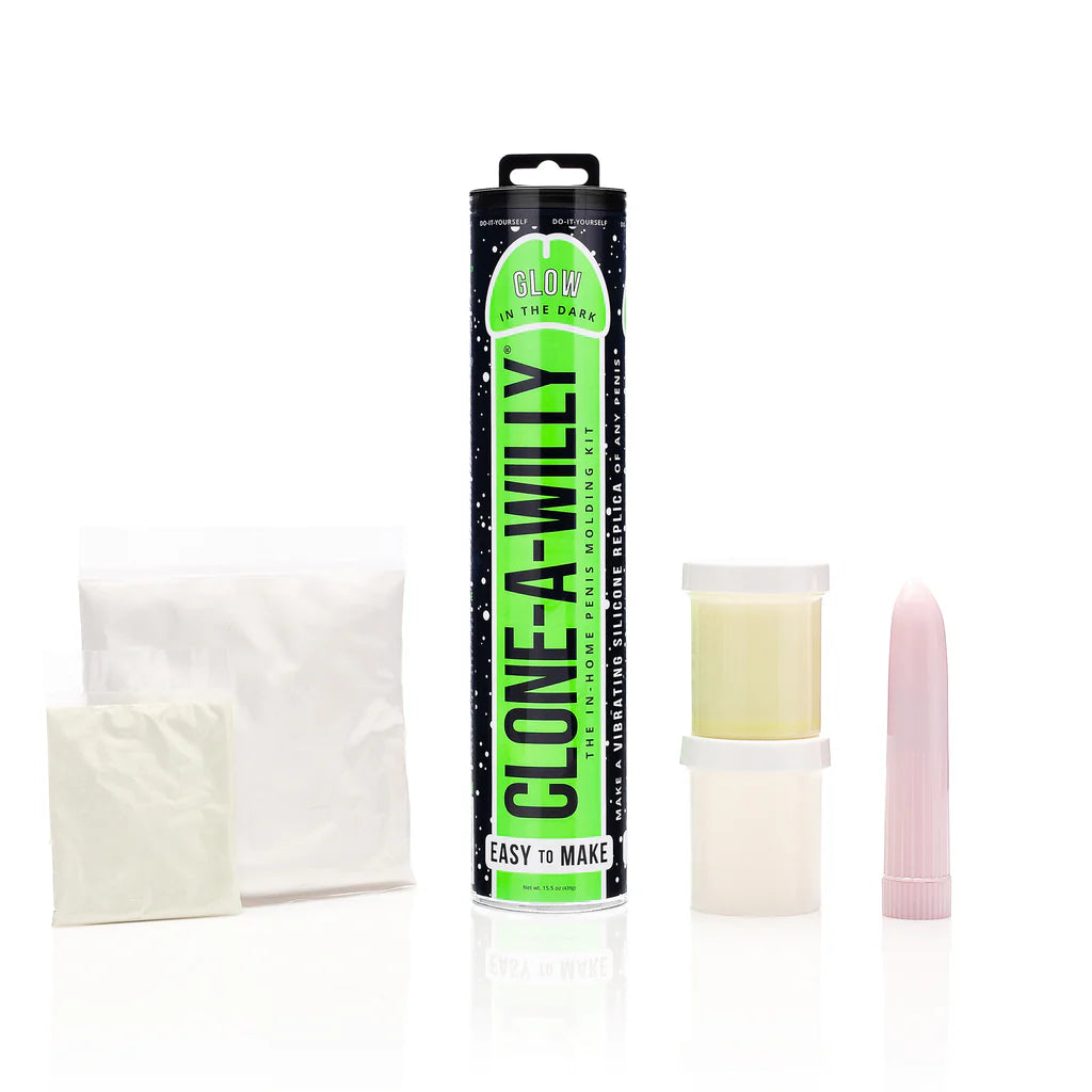 Clone-A-Willy product set with packaging, materials, and a candle on a white background