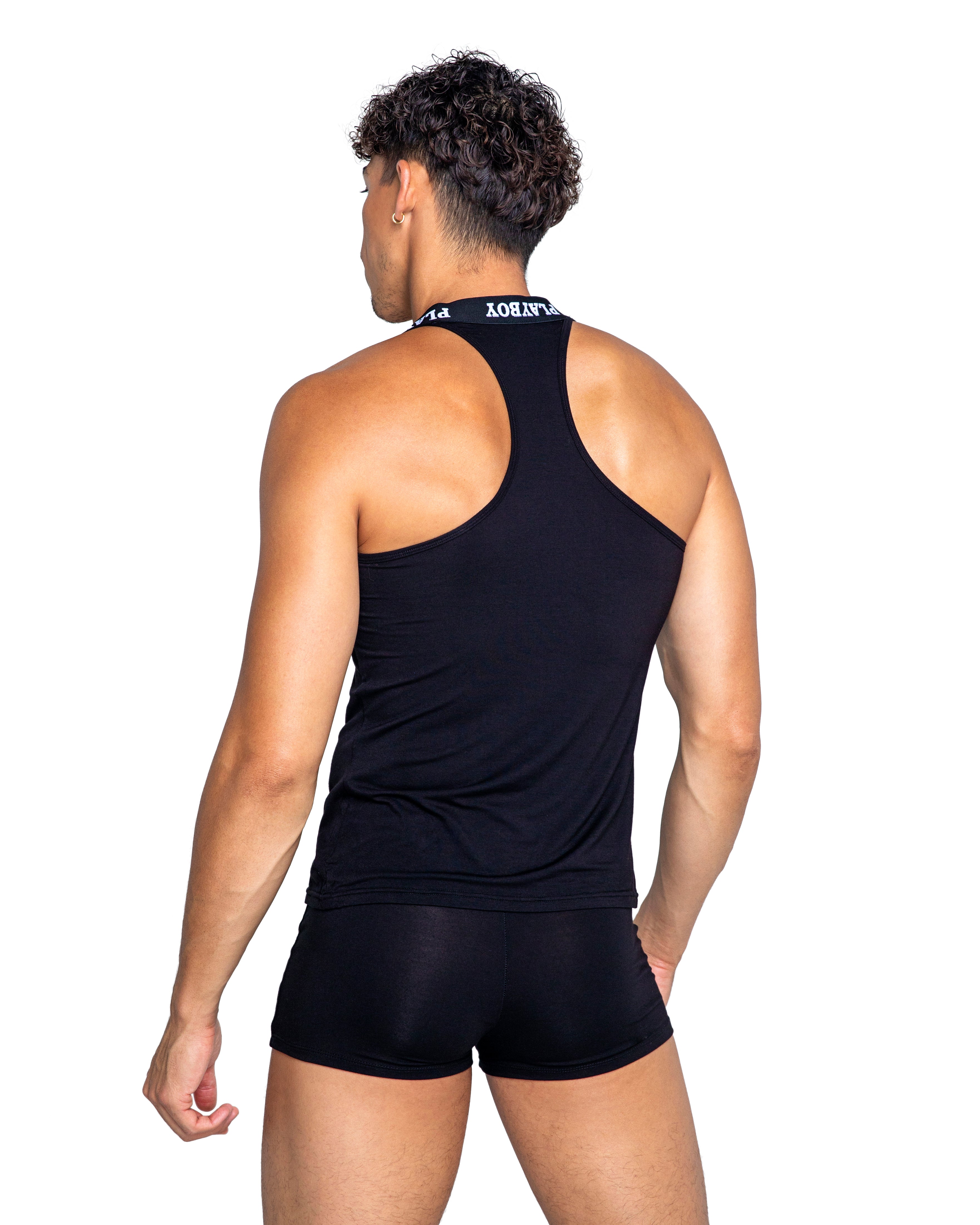 Person wearing a black tank top and shorts on a white background