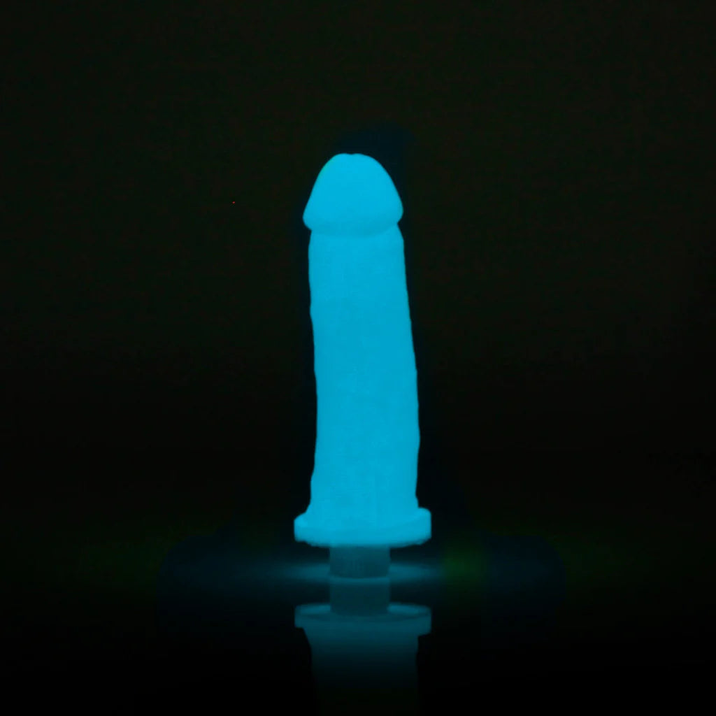 A glowing blue adult novelty product on a stand against a black background.